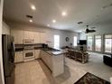 Open concept kitchen with island and living room view at 323 Travelers Dr, Polk City, FL 33868