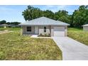 Newly built home with metal roof and gray siding at 522 S Perry Ave, Fort Meade, FL 33841