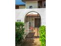 Inviting entryway with wrought iron gate leading to a private patio at 103 Coventry Ln, Haines City, FL 33844