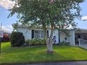 Single-story home with carport, landscaping, and large tree at 462 Cameo Dr # 462, Lakeland, FL 33803