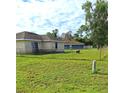 Large grassy backyard with chain link fence at 522 Raymond Ave, Frostproof, FL 33843