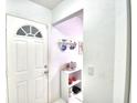 Bright and airy entryway with white door and small shelving unit at 3258 Triple Crown Ln, Lakeland, FL 33811