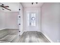 Bright entryway with gray wood-look flooring, white door, and access to other rooms at 5017 Ridgefield Lane, Lakeland, FL 33812