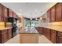 Gourmet kitchen with granite countertops and island at 6529 Longwood Trace S Ln, Lakeland, FL 33811
