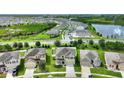 Community overview featuring homes, lake, and green spaces at 3230 Bayou Bay Dr, Lakeland, FL 33811