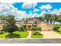 Beautiful lakefront home with manicured landscaping at 4848 Island Shores Ln, Lakeland, FL 33809