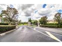 Gated community entrance with stone pillars and landscaping at 4848 Island Shores Ln, Lakeland, FL 33809