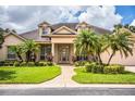 Two-story home with columns, palm trees and manicured lawn at 4848 Island Shores Ln, Lakeland, FL 33809