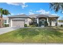 Single-story house with a two-car garage and well-manicured lawn at 4756 Acorn Dr, Mulberry, FL 33860