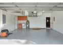 Spacious garage with built-in cabinets, sink, and overhead storage at 4756 Acorn Dr, Mulberry, FL 33860