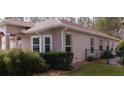 Side view of a one-story house with a brown stucco exterior at 183 Hamlet Trce, Ormond Beach, FL 32174