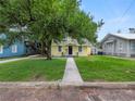 House with a walkway leading to the front door and a large tree in the front yard at 714 Winfree Ave, Lakeland, FL 33801
