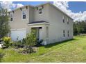 Two-story house, light beige with green accents at 1782 Eagle Hammock Blvd, Eagle Lake, FL 33839