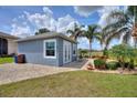 Guest house with gray exterior, paved patio, and lush landscaping at 544 Narrow Pond Rd, Polk City, FL 33868