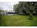 Large backyard with grassy area and screened porch at 1216 Pinewood Ave, Lakeland, FL 33815