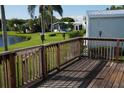 Wooden deck overlooking a tranquil lake and lush landscape at 2147 Cypress Cross Dr, Lakeland, FL 33810