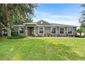 One-story home with green lawn and stone accents at 1001 Lena Run Ct, Winter Haven, FL 33880