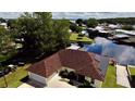 Aerial view showing home's canal-front location and solar panels at 180 Lakeview Dr, Haines City, FL 33844