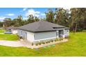 New construction home with gray exterior, landscaped yard, and driveway at 1896 12Th St, Orange City, FL 32763