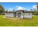 Newly built home with gray exterior, landscaping, and driveway at 1896 12Th St, Orange City, FL 32763