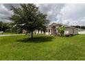 Single-story house with large grassy yard at 1619 Prairie Blossom Dr, Lakeland, FL 33810