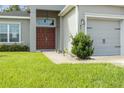 Red double doors and walkway leading to the front entrance of a house at 8218 Wilder Loop, Lakeland, FL 33809