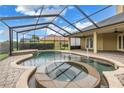 Relax in the screened pool and spa, surrounded by a paver deck at 6414 Highlands In The Woods St, Lakeland, FL 33813