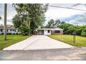 Brick ranch house with carport and large lawn at 415 Lucille St, Bartow, FL 33830