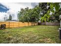 Large grassy backyard with wooden fence at 415 Lucille St, Bartow, FL 33830