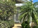 Front entrance with lush landscaping and walkway at 1045 Caravan Loop, Polk City, FL 33868