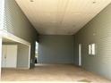 Covered carport with concrete flooring and storage at 1045 Caravan Loop, Polk City, FL 33868