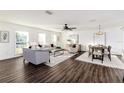 Bright living room features hardwood floors, comfy seating, and large windows at 4618 Crestview Ln, Lakeland, FL 33813