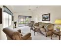 Bright living room with comfy seating, large window, and access to a screened patio at 6205 Raven Run, Lakeland, FL 33809
