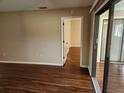 Living room with laminate flooring and access to screened porch at 6128 Topher Trl # 6128, Mulberry, FL 33860