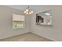 Dining area with tile floors and view into kitchen at 6838 Glenbrook Dr, Lakeland, FL 33811