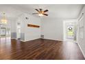 Living room with dark hardwood floors and ceiling fan at 1618 Birchwood Loop, Lakeland, FL 33811
