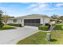 Exterior view of a single story home with garage and driveway at 1618 Birchwood Loop, Lakeland, FL 33811
