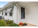 Side view of a house showing exterior door and landscaping at 1618 Birchwood Loop, Lakeland, FL 33811