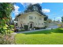 Two-story house with a detached garage and a spacious lawn at 415 E Maxwell St, Lakeland, FL 33803