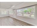 Bright living room with wood-look floors and large windows at 105 Mason St, Auburndale, FL 33823