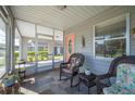 Relaxing screened porch with wicker furniture at 4829 Colonnades E Cir, Lakeland, FL 33811