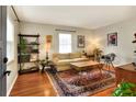 Living room with hardwood floors, rug, and mid-century modern furniture at 1819 Meadowbrook Ave, Lakeland, FL 33803