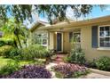 Front view of a charming house with lush landscaping at 1819 Meadowbrook Ave, Lakeland, FL 33803