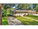 Charming bungalow with screened porch and well-manicured lawn at 1127 N Stella Ave, Lakeland, FL 33805