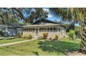 House exterior showcasing a screened porch and landscaped yard at 1127 N Stella Ave, Lakeland, FL 33805