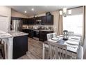 Spacious kitchen with dark cabinetry, granite countertops, and stainless steel appliances at 5675 Maddie Dr, Haines City, FL 33844