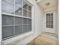 Exterior of villa entryway with white door and window at 733 Carpenters Way # 20, Lakeland, FL 33809