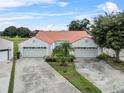 Two villas with attached garages, featuring Spanish-style architecture at 733 Carpenters Way # 20, Lakeland, FL 33809