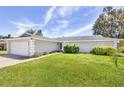 Single story home with attached garage and manicured lawn at 2233 20Th Nw St, Winter Haven, FL 33881