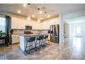 Modern kitchen with white cabinets, granite island, and stainless steel appliances at 731 Griffon Ave, Lake Alfred, FL 33850